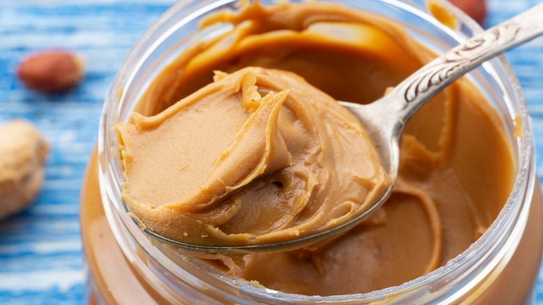 spoon of peanut butter in jar