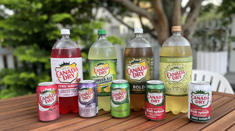 Canada Dry bottles and cans on wooden tables outdoor