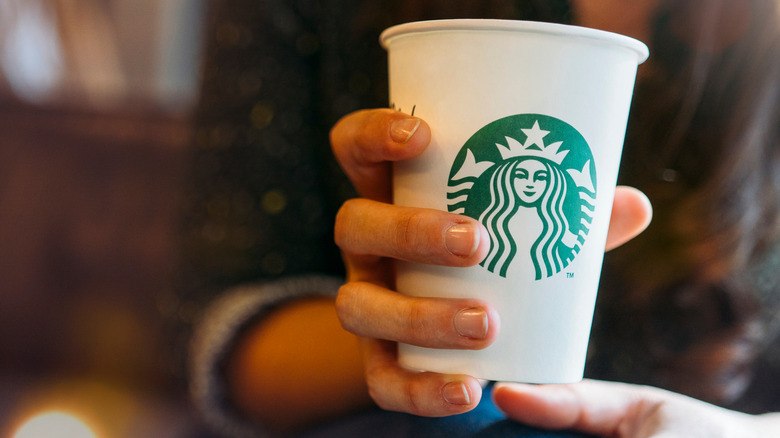 Person holding a Starbucks cup