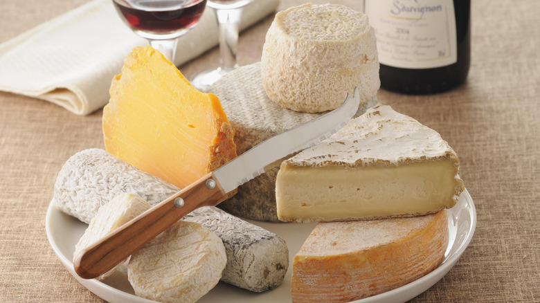 assorted cheeses with knife