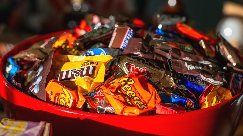 Red bowl of assorted Halloween candy