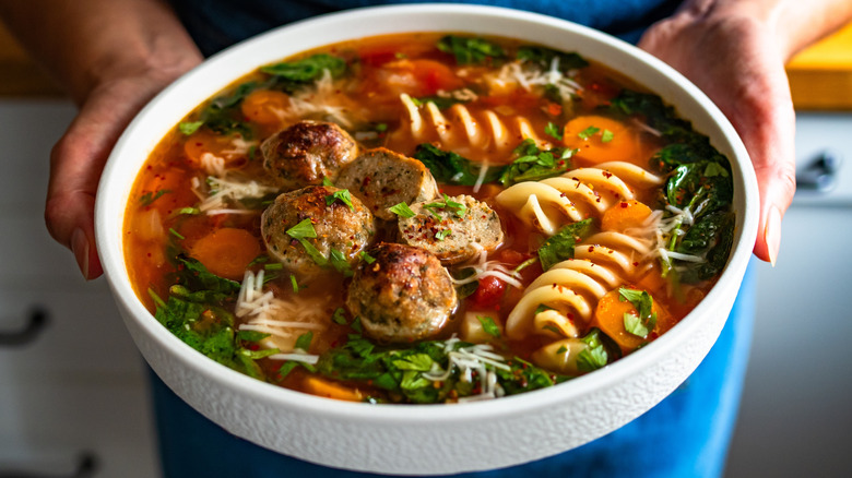a person hold italian wedding soup