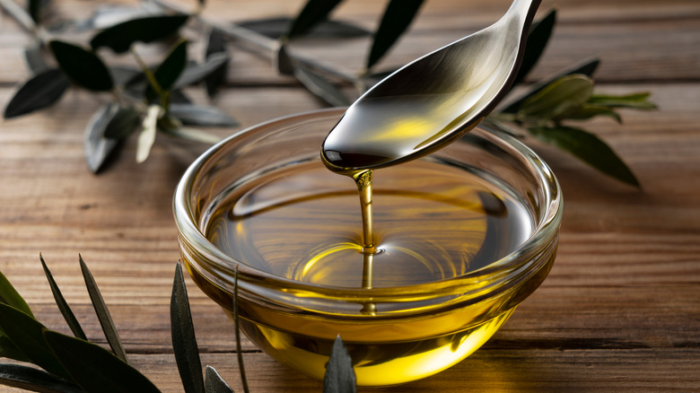 spoonful of olive oil into bowl