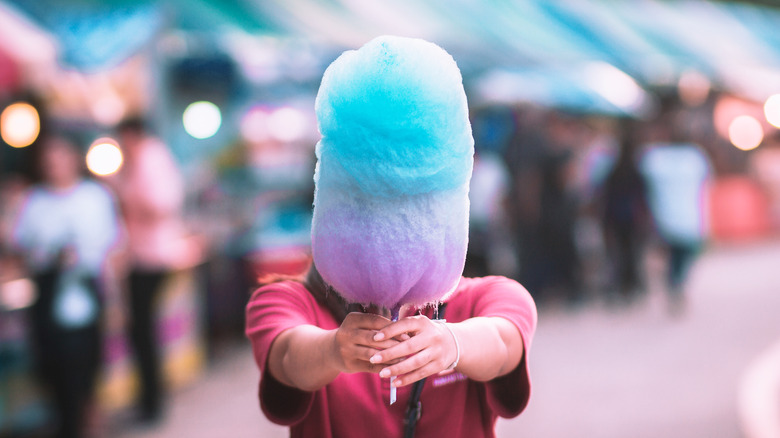Woman holding cotton candy 