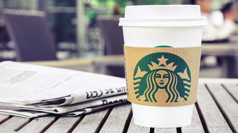 Starbucks cup and newspaper