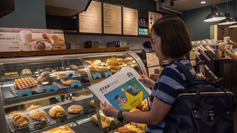 Woman reading at Starbucks counter