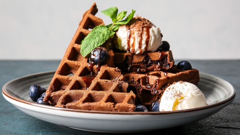 waffles, blueberries and ice cream on plate