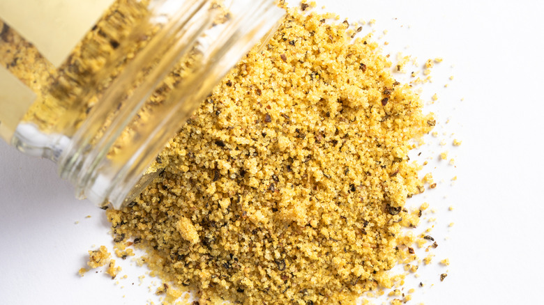 pouring lemon pepper from jar