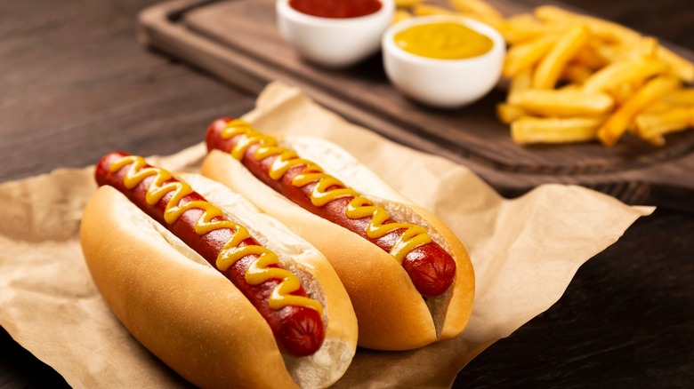 Hot dogs with mustard on paper 