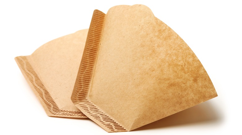 Brown coffee filters on white background