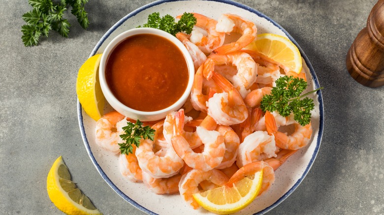 shrimp cocktail on white plate with parsley 