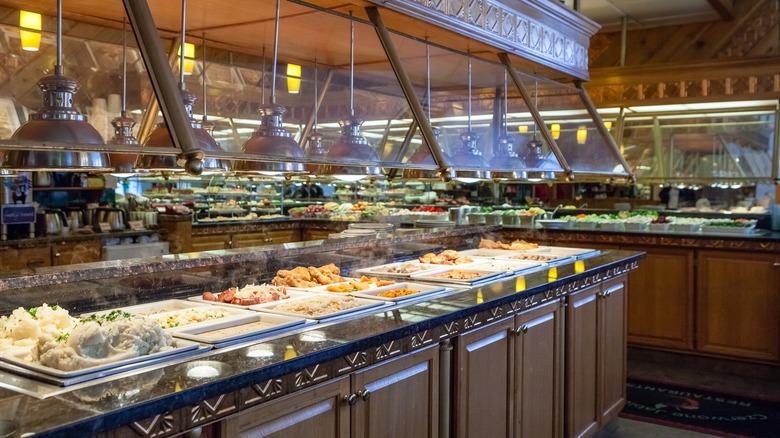 Buffet restaurant with multiple prepared dishes and sneeze guards