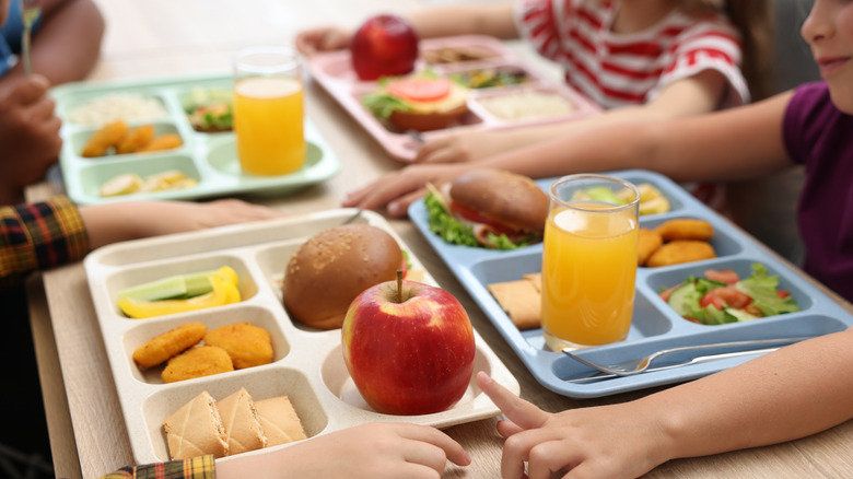 Kids with school lunch trays