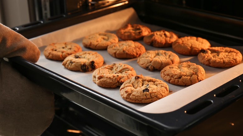 Taking cookies out of oven