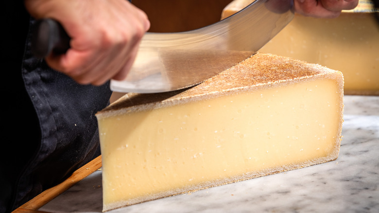 cutting wedge of Gruyère with rocker knife
