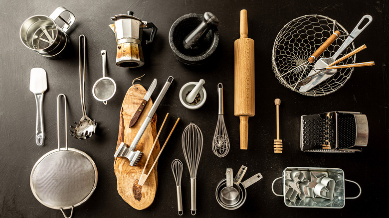 An assortment of steel and wooden kitchen tools