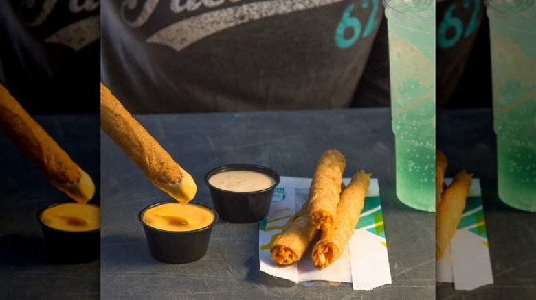Taco Bell taquitos being dipped in various sauces
