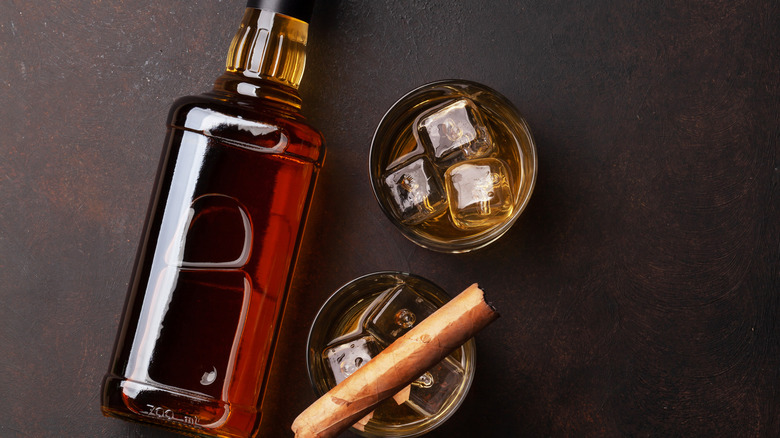 Bottle, cocktails, and cigar