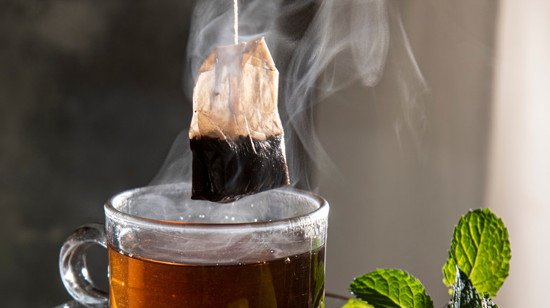 tea bag pulled out of hot tea cup