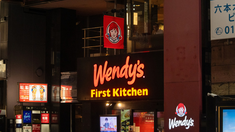 A street sign for a Wendy's location in Japan, branded "Wendy's First Kitchen"