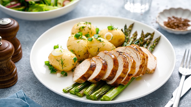 Cooked, sliced chicken breast on asparagus 