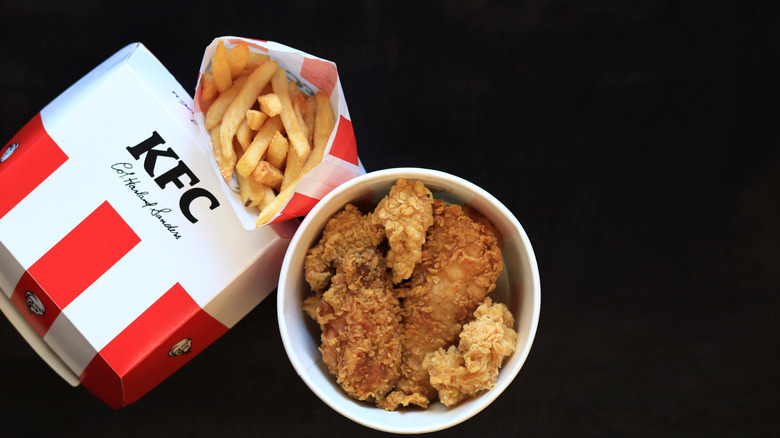 Bucket of KFC fried chicken with french fries and burger box