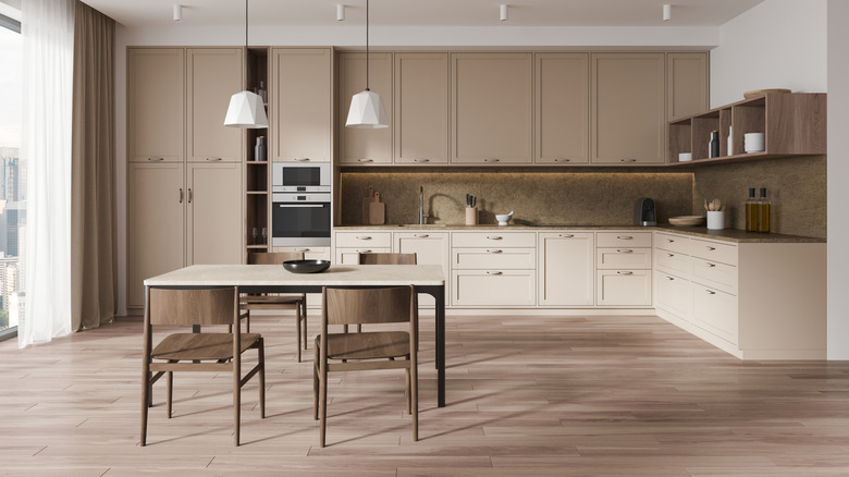 An L-shaped kitchen painted in neutral colors