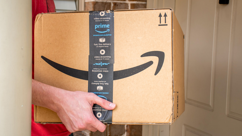 Person receiving Amazon prime delivery box