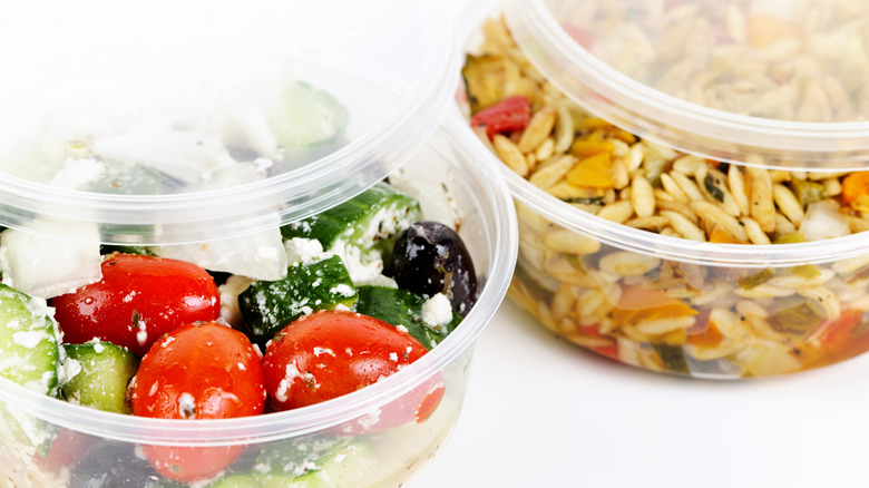 Deli containers with salads in them