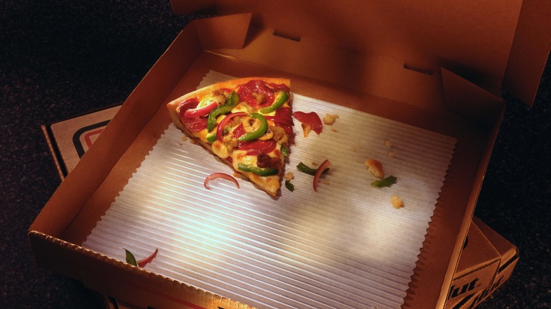 slice of leftover pizza in box