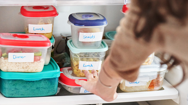 Woman reaching for leftovers