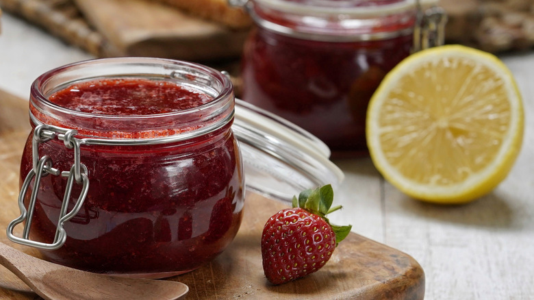 Jar of strawberry jam with a lemon half
