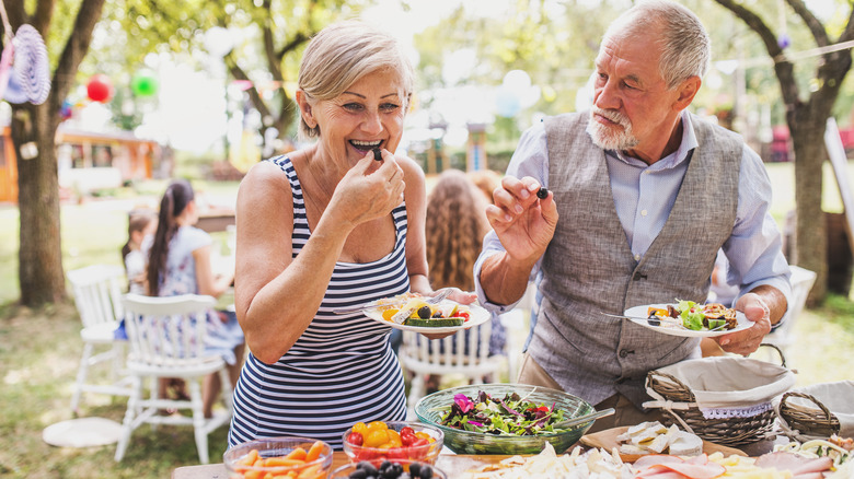 people eating food outside 