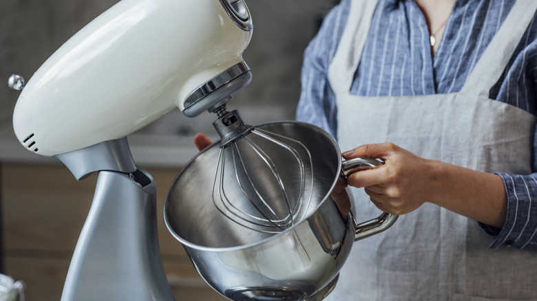 Person holding stand mixer bowl