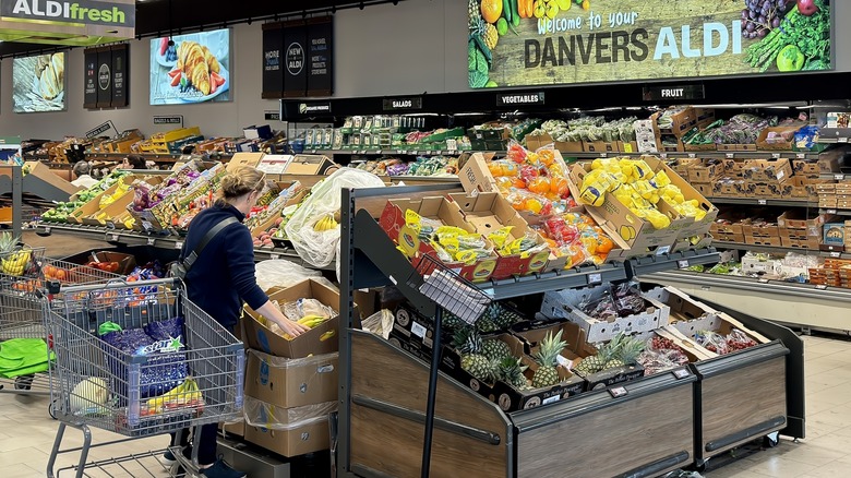 View of customer shopping for fruit in Aldi's produce section