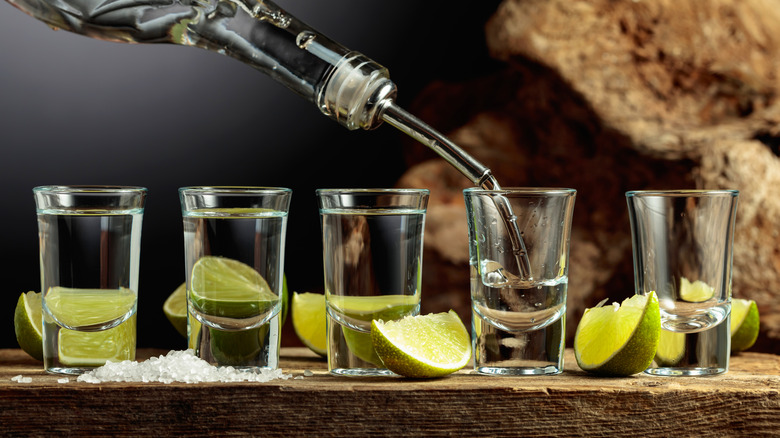 Tequila poured from bottle into shot glasses