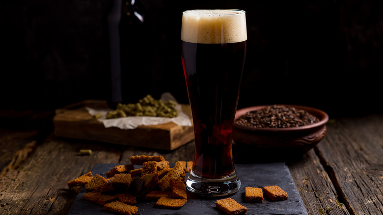 Glass of dark beer and snacks