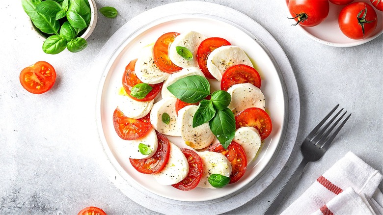 Caprese salad on white plate 