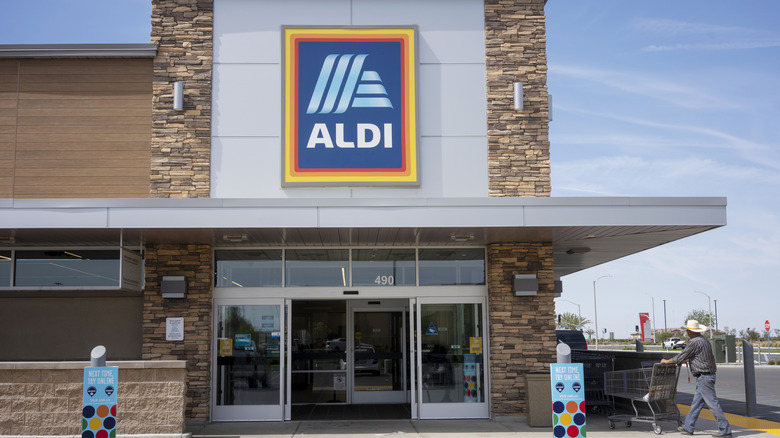 Aldi storefront with a customer entering