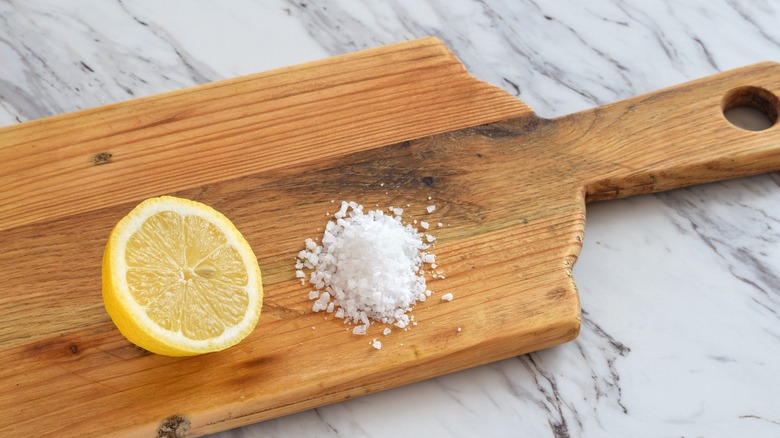 Lemon and salt on a cutting board