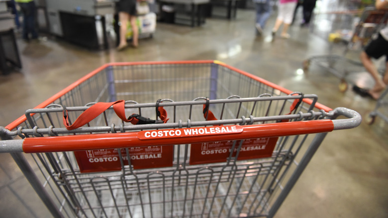 Costco shopping cart parked in front of registers
