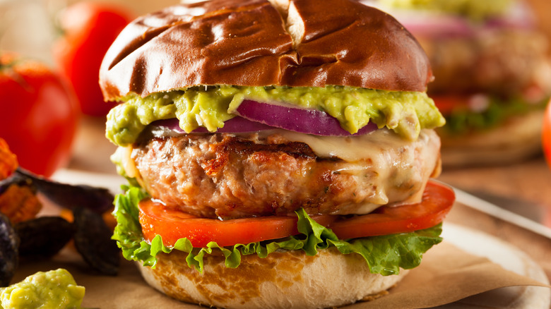 chicken burger topped with guacamole