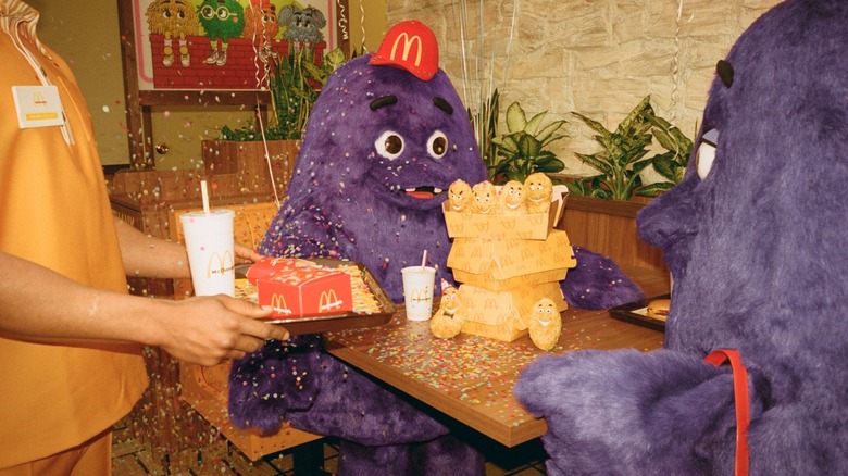Grimace celebrating birthday at mcdonald's 