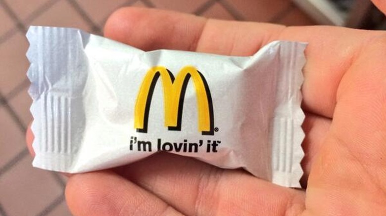 hand holding McDonald's buttermint