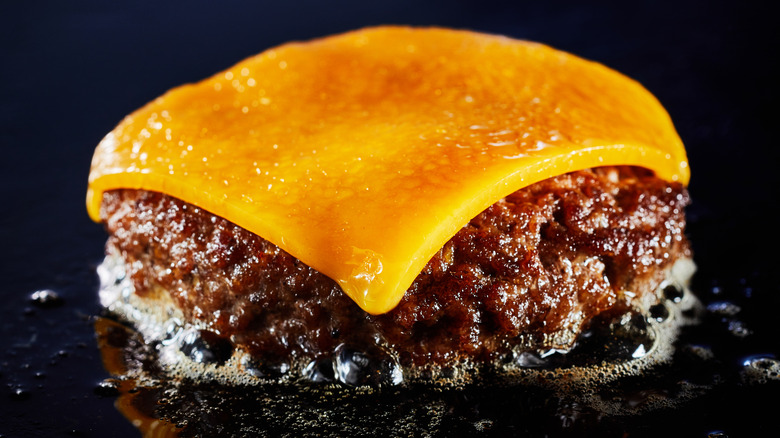 cheeseburger on griddle