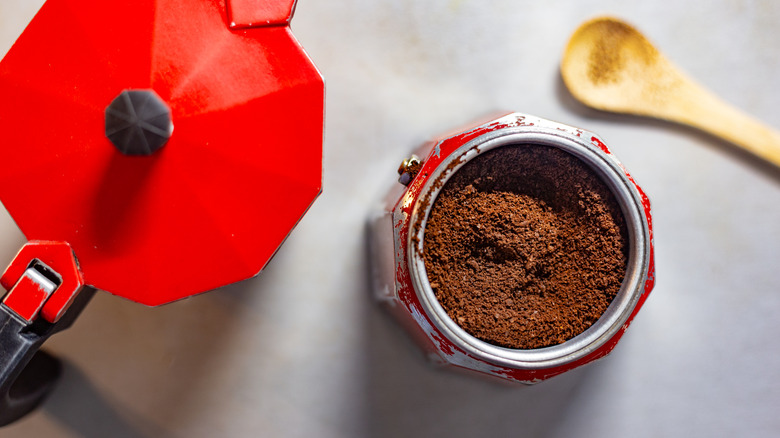 top down of red moka pot and grind basket