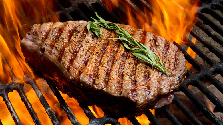 steak being seared on grill
