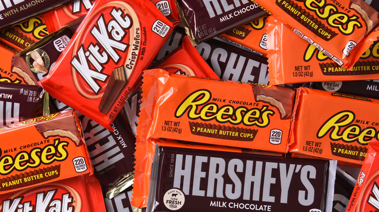 Pile of KitKat, Reese's, and Hershey's bars