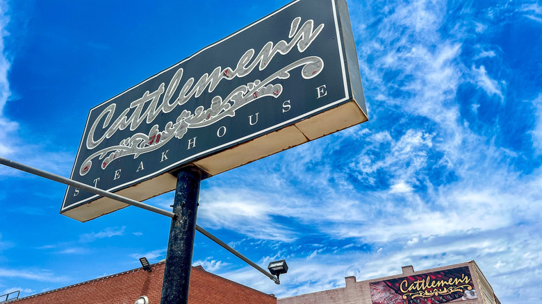 The sign for Cattlemen's Steakhouse against a blue sky