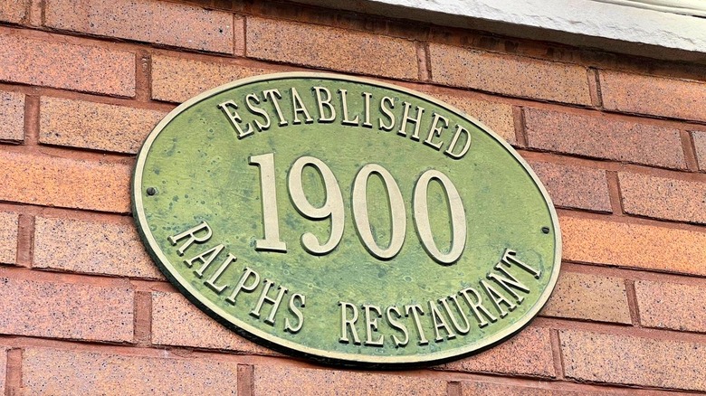 Sign on a brick wall for Ralph's restaurant, established 1900